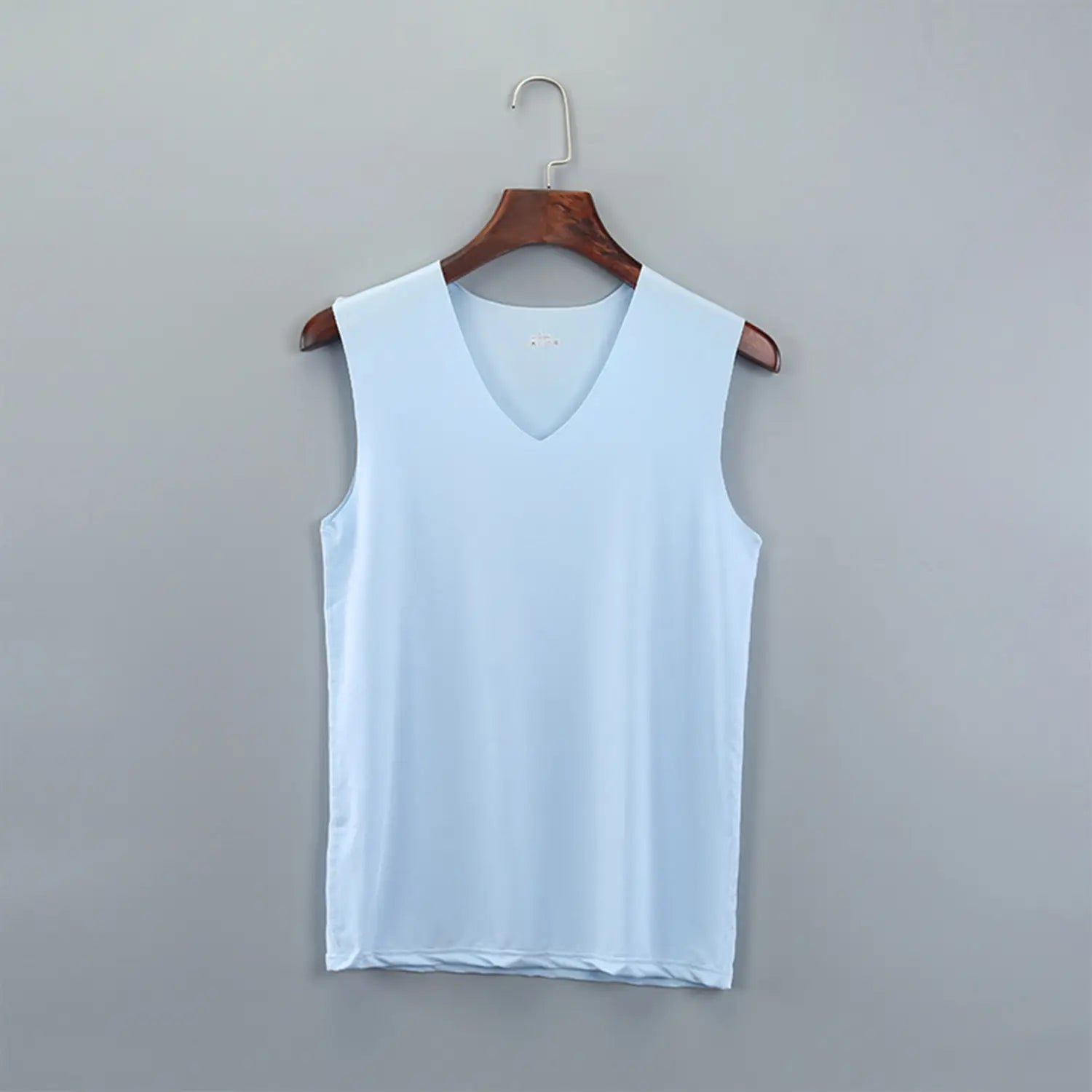 Men ice silk v-neck sleeveless tank top in light blue hanging on a wooden hanger.
