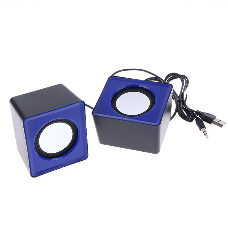 Blue and black cube-shaped USB desktop speakers with circular speaker grilles on each face for stereo audio computer system use.
