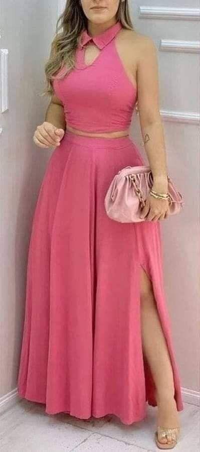 A vibrant pink halter two piece set featuring a collar closure type top with cutout detail paired with a flowing high-slit maxi skirt.