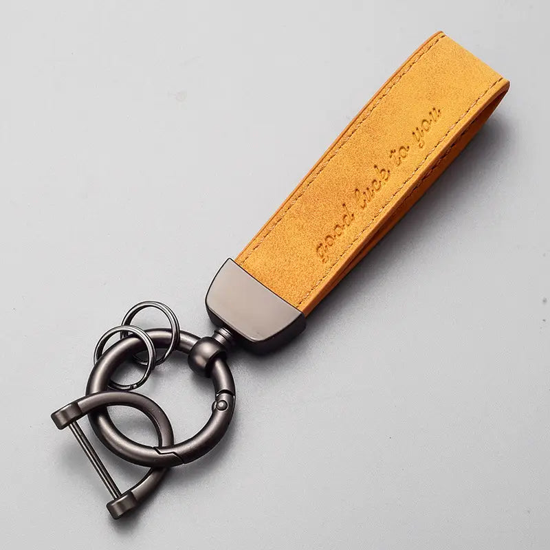 Tan suede leather car keychain with brushed metal clasp engraved with good luck to you phrase luxury genuine leather key ring.