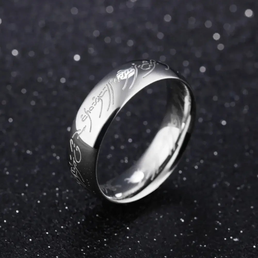 Silver stainless steel wedding band ring with engraved golden elvish script along its band