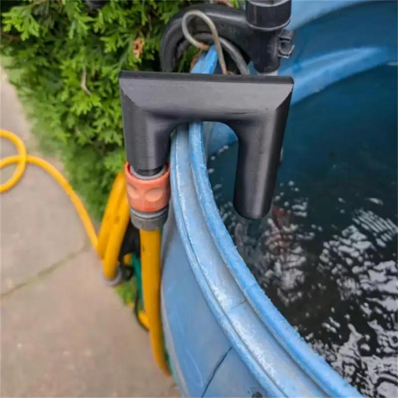 Black plastic pool filter clamp securing a yellow garden hose to the side of a blue above-ground swimming pool demonstrating water flow control with a 3d printed PLA polylactic acid water nozzle.