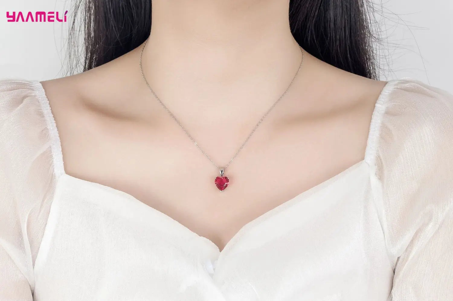 A delicate sterling silver chain necklace featuring a vibrant red heart-shaped pendant as part of the sterling silver heart jewelry set zircon huggies.