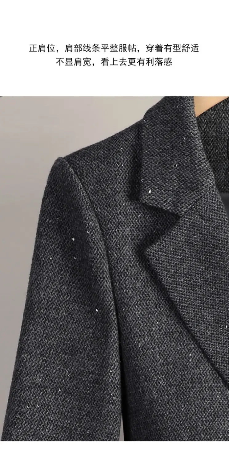 Dark gray textured wool blend double breasted blazer with structured shoulders and notched lapel.