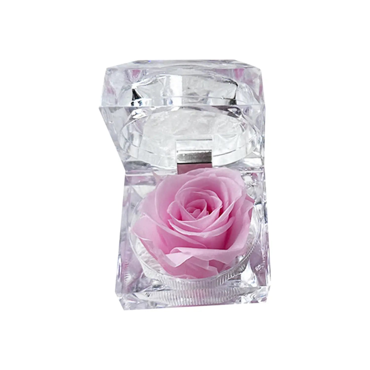 A delicate pink preserved rose nestled inside a clear faceted crystal gift box in the preserved rose crystal gift box eternal flower.