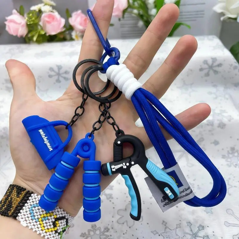 Blue and black hand grip keychain set with silicone handles and a carabiner clip for fitness keychain mini gym equipment bag pendant.