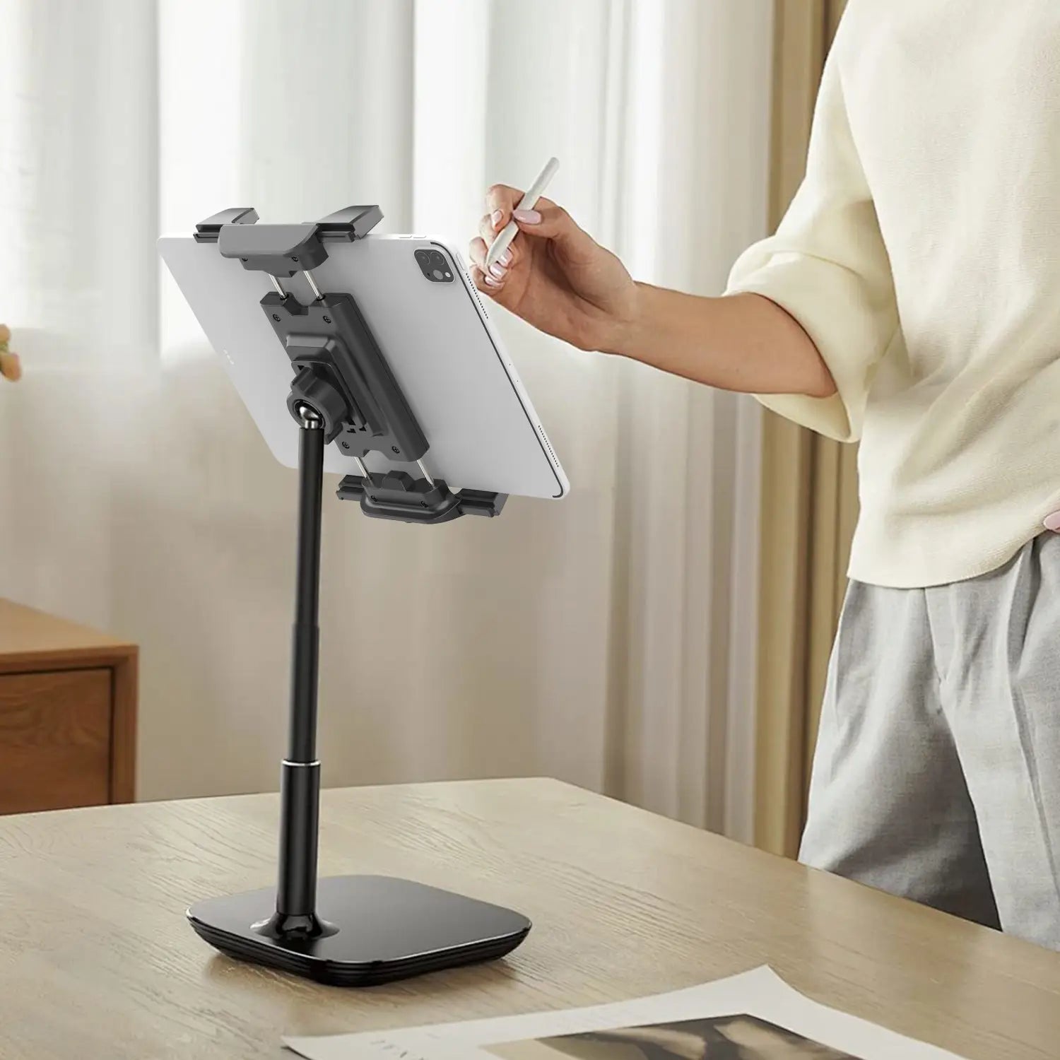 black adjustable length tablet holder tripod holding a white ipad in a universal mount design