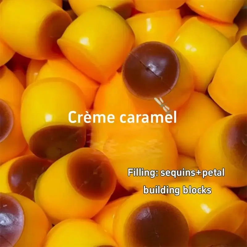 Front view of vibrant yellow creme caramel stress ball toy with glossy tops and dark centers filled with sequins and petals