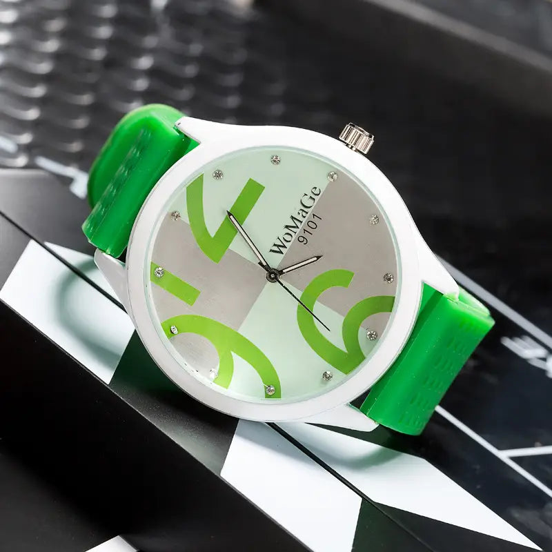 A womage green silicone quartz fashion watch with a vibrant green and white dial, glossy silicone strap, silver-toned case, and bold lime-green abstract numerals.