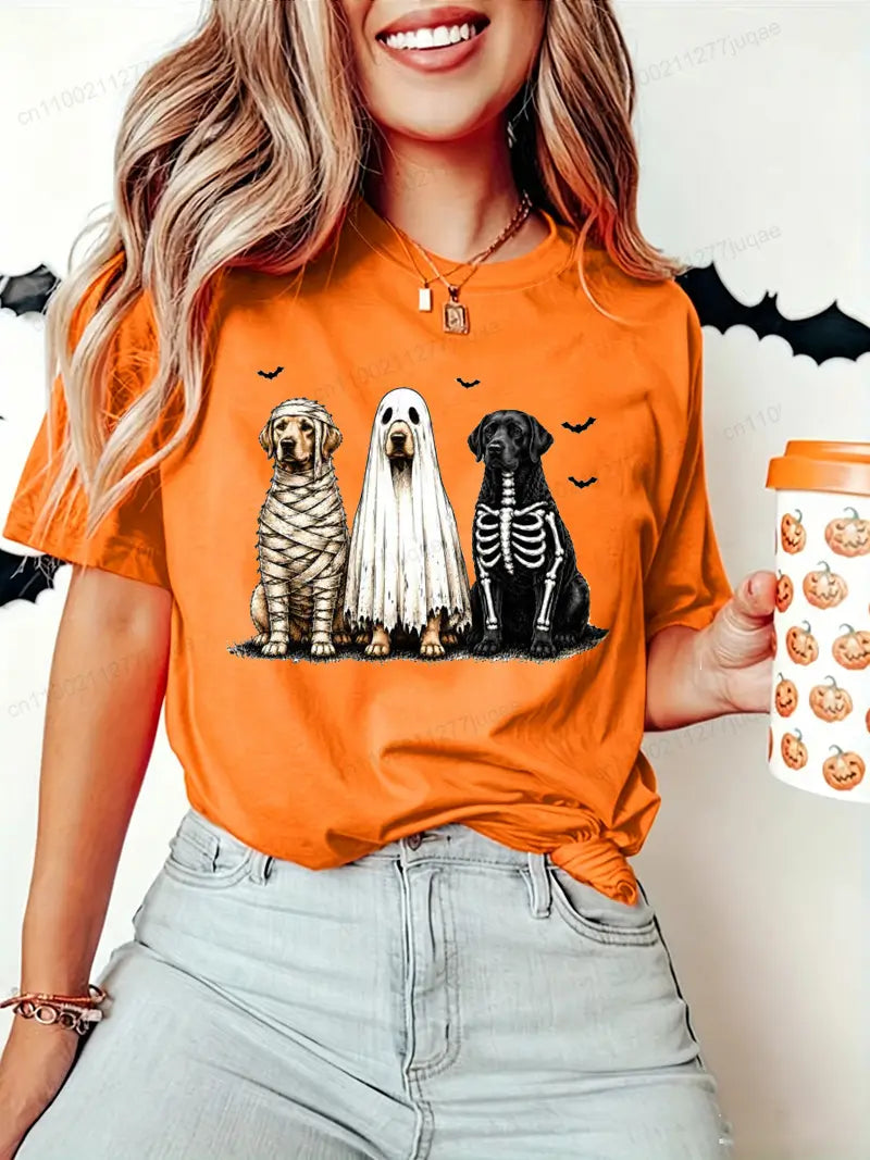 Orange women’s t-shirt short sleeve featuring a Halloween dog graphic with three dogs dressed as mummy, ghost, and skeleton.