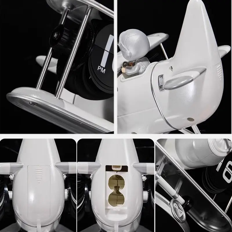 white plastic and metal model of a vintage biplane with silver accents serving as an airplane flip desk clock and vintage table decor