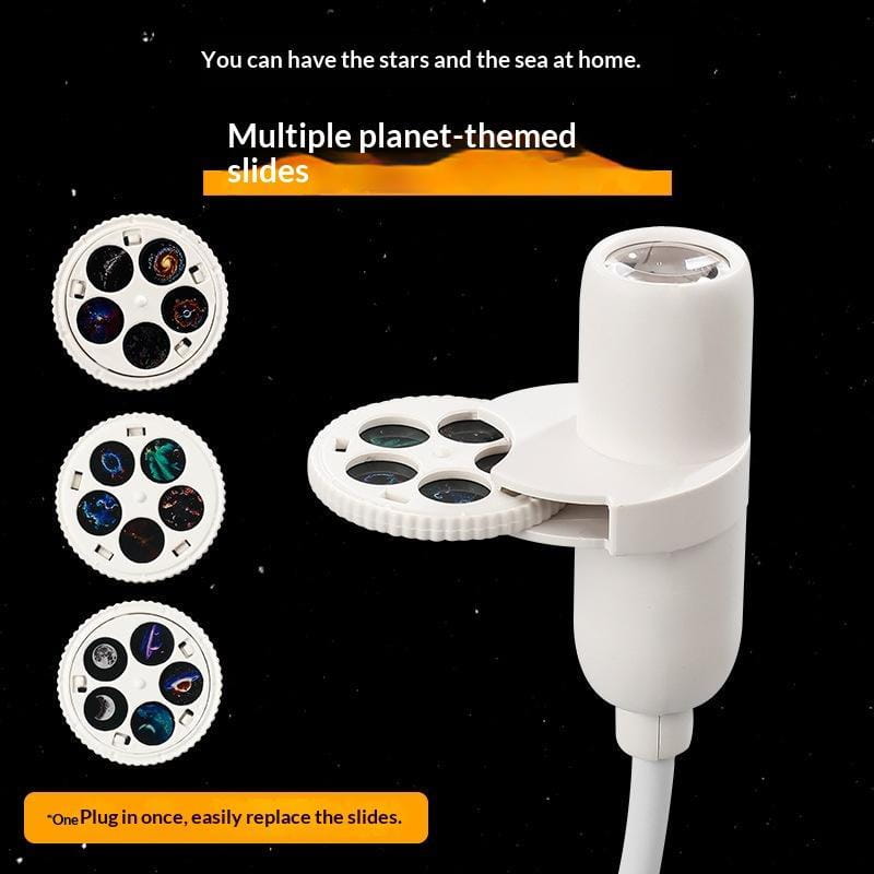 White plastic usb powered galaxy projector with flexible neck and interchangeable planet-themed slides featuring colorful celestial imagery viewed from the front.