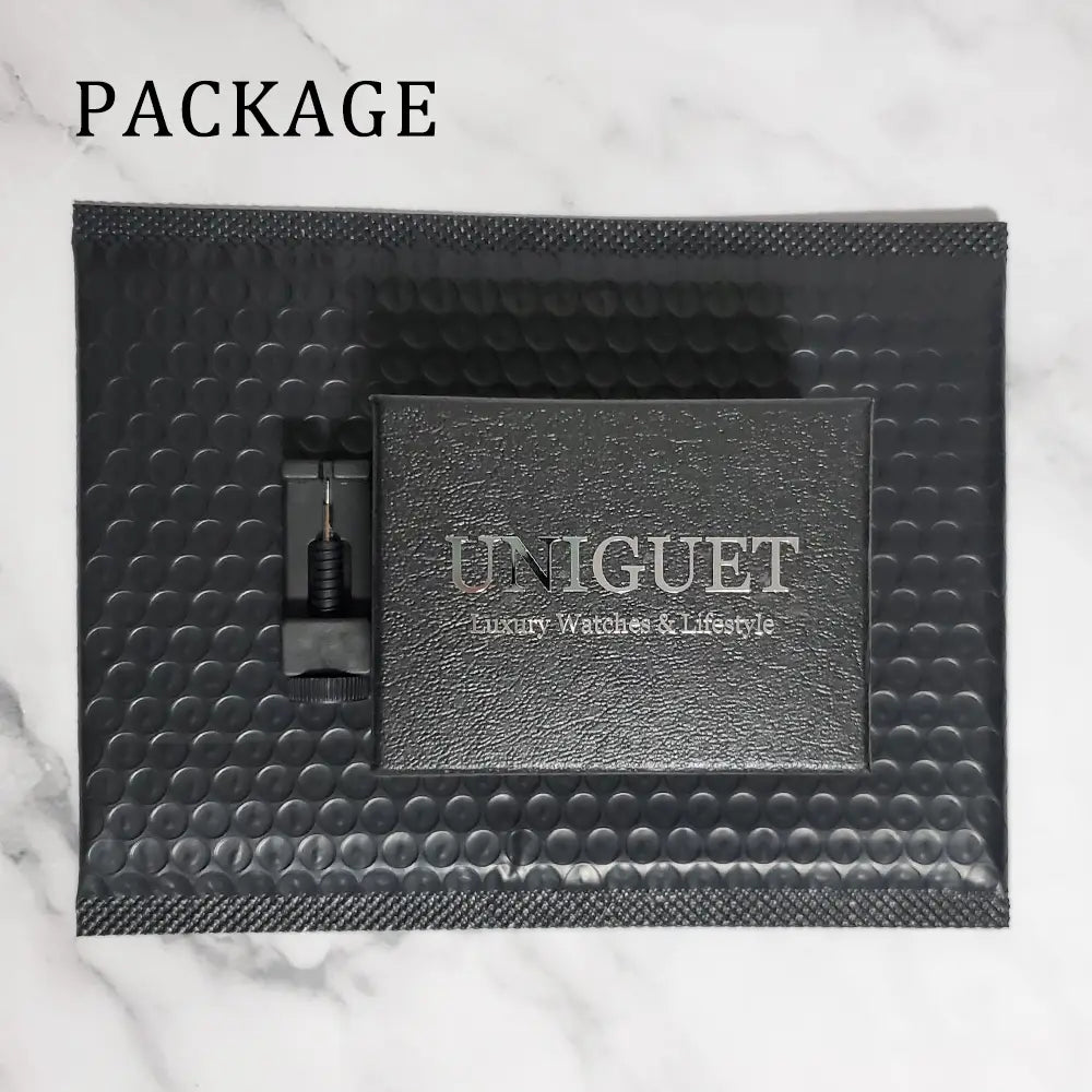 Black textured leather box with silver embossed uniguet luxury watches and lifestyle branding for iced diamond men’s quartz watch luxury silver hip hop timepiece.