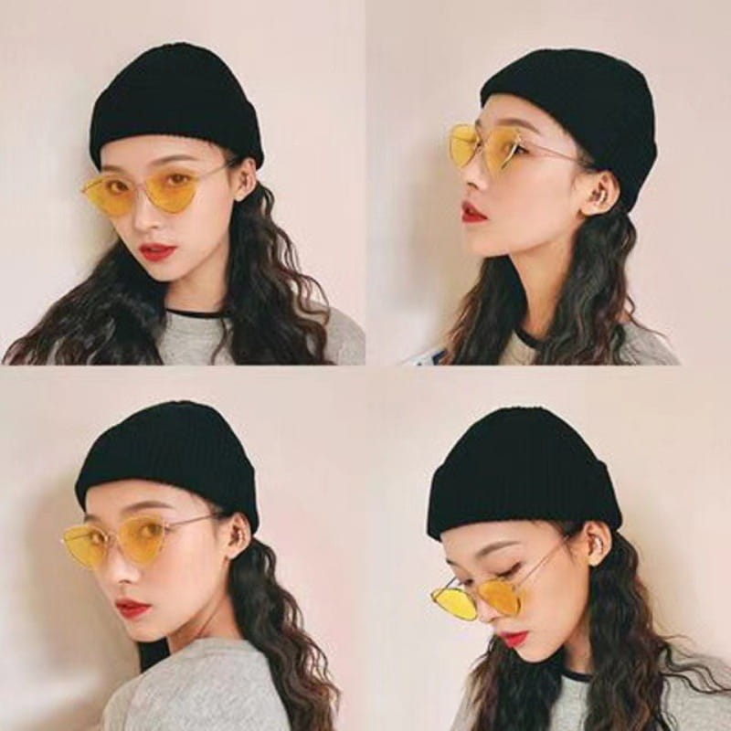 Black ribbed knit winter beanie hat made of warm material suitable for unisex use showing the back side of the cap.