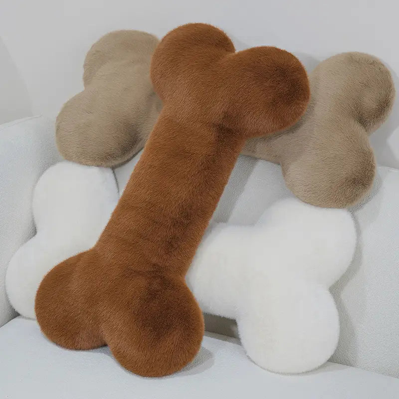 a plush brown faux fur bone shape plush pillow with a soft fluffy texture designed as a kawaii bone shape soft nap cushion