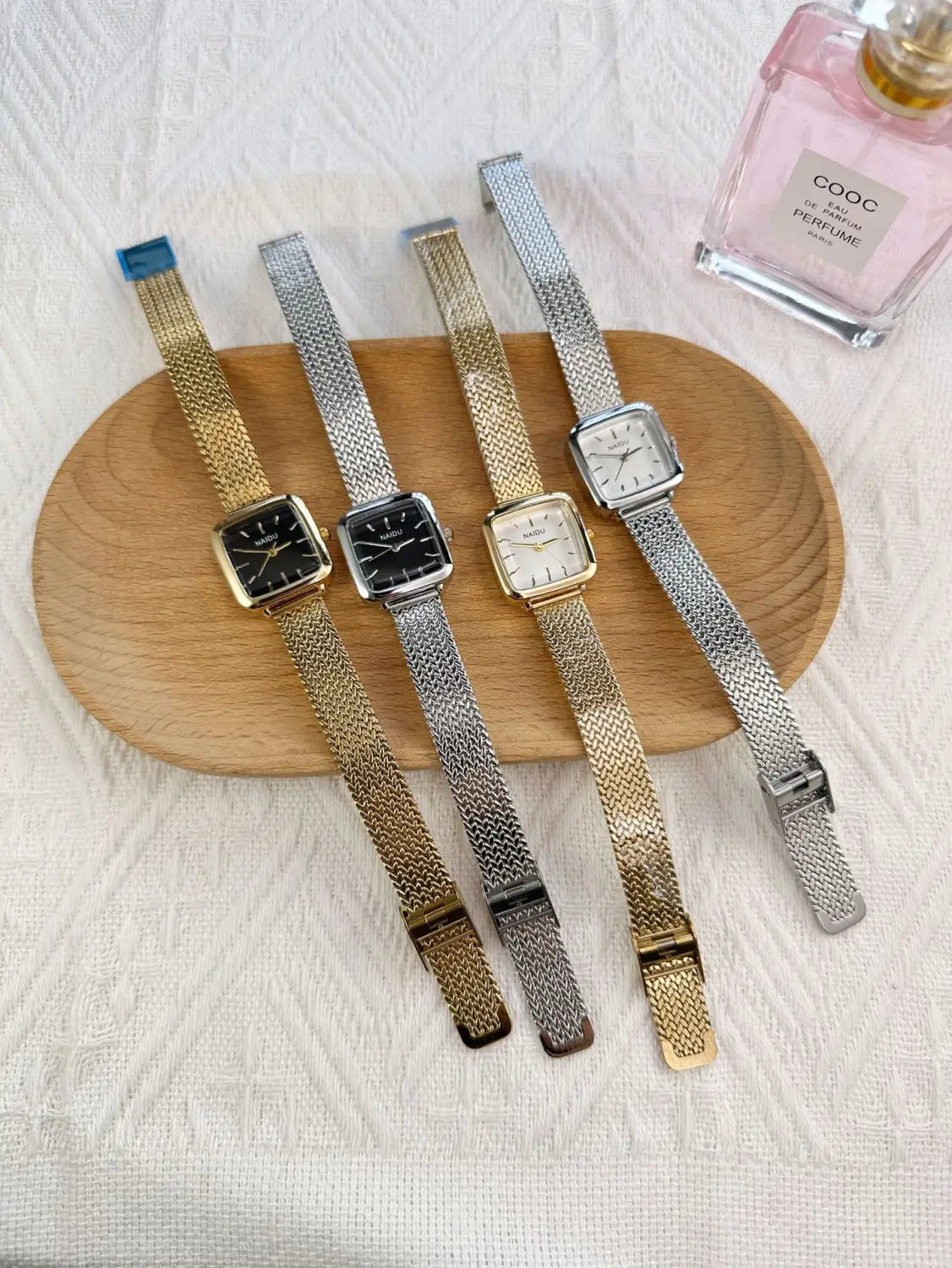 Four elegant minimalist square quartz watches for women with mesh bands in gold and silver tones featuring black or white dials.