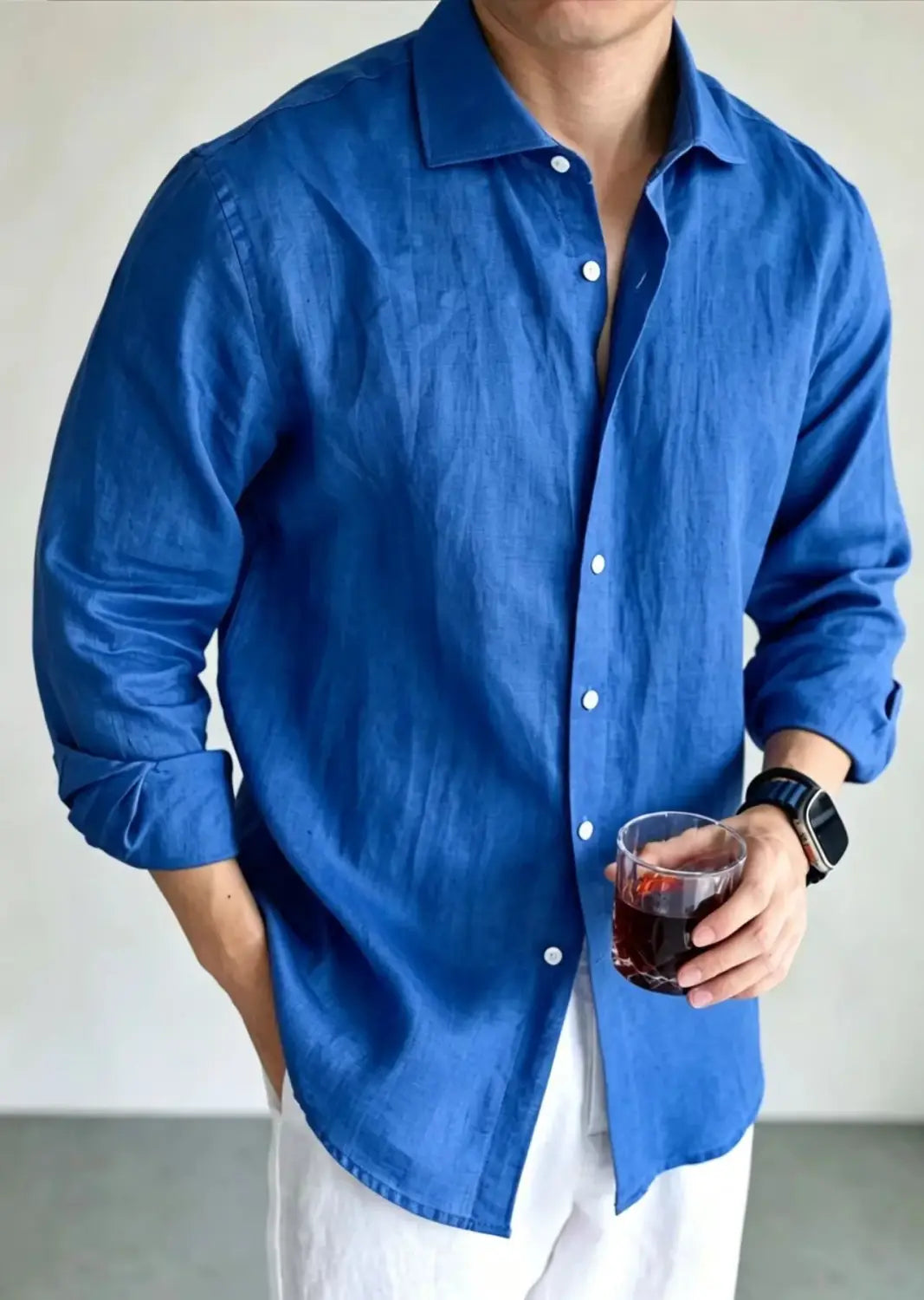 A rich royal blue men’s cotton linen casual button down shirt with a classic collar and white buttons.