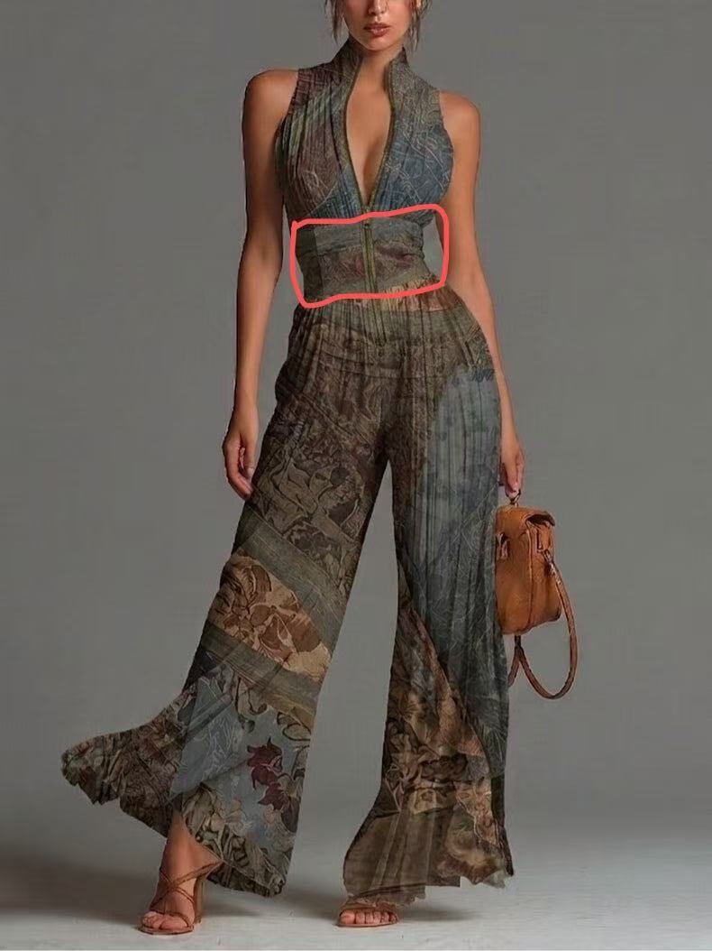 A wide patterned belt with a central zipper closure and subtle metallic accents paired with a pleated chiffon wide leg jumpsuit.