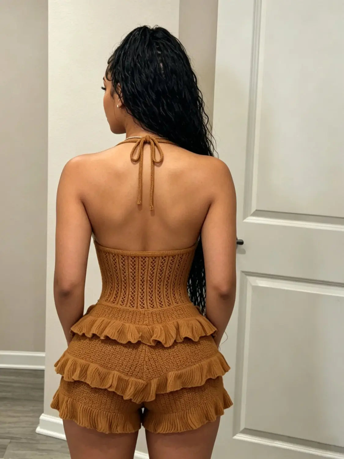 A tan knitted two-piece set featuring a corset-style top and layered ruffle shorts designed as a knitted ruffle halter romper summer playsuit.
