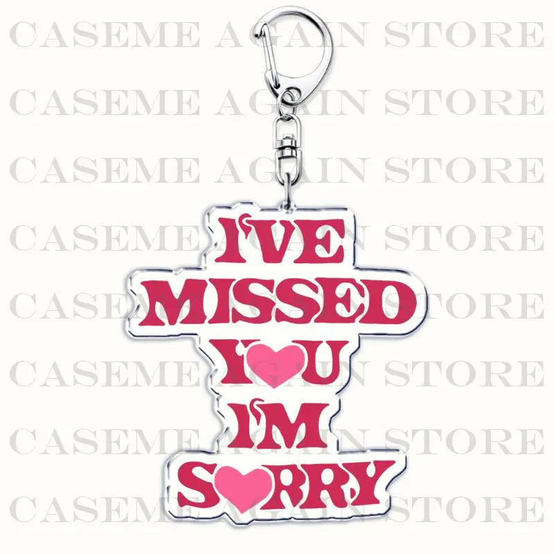 A pink acrylic Gracie Abrams keychain featuring bold lettering with the message ive missed you im sorry heart symbols and a silver metal clasp designed as an anime fan gift.