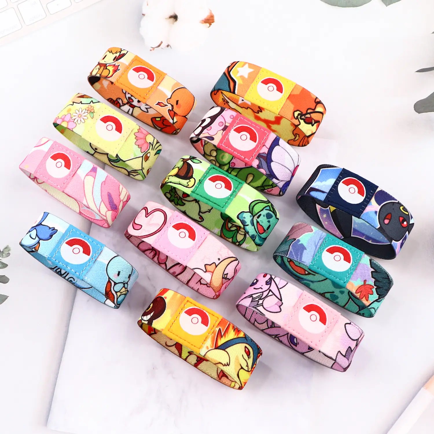 colorful stretch wristband bracelet featuring fabric material with vibrant Pokémon-themed character prints and a central poké ball logo.