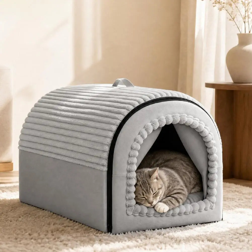Gray plush pet bed cave with ribbed texture and pom-pom trim made of washable warm cotton for cozy indoor use.