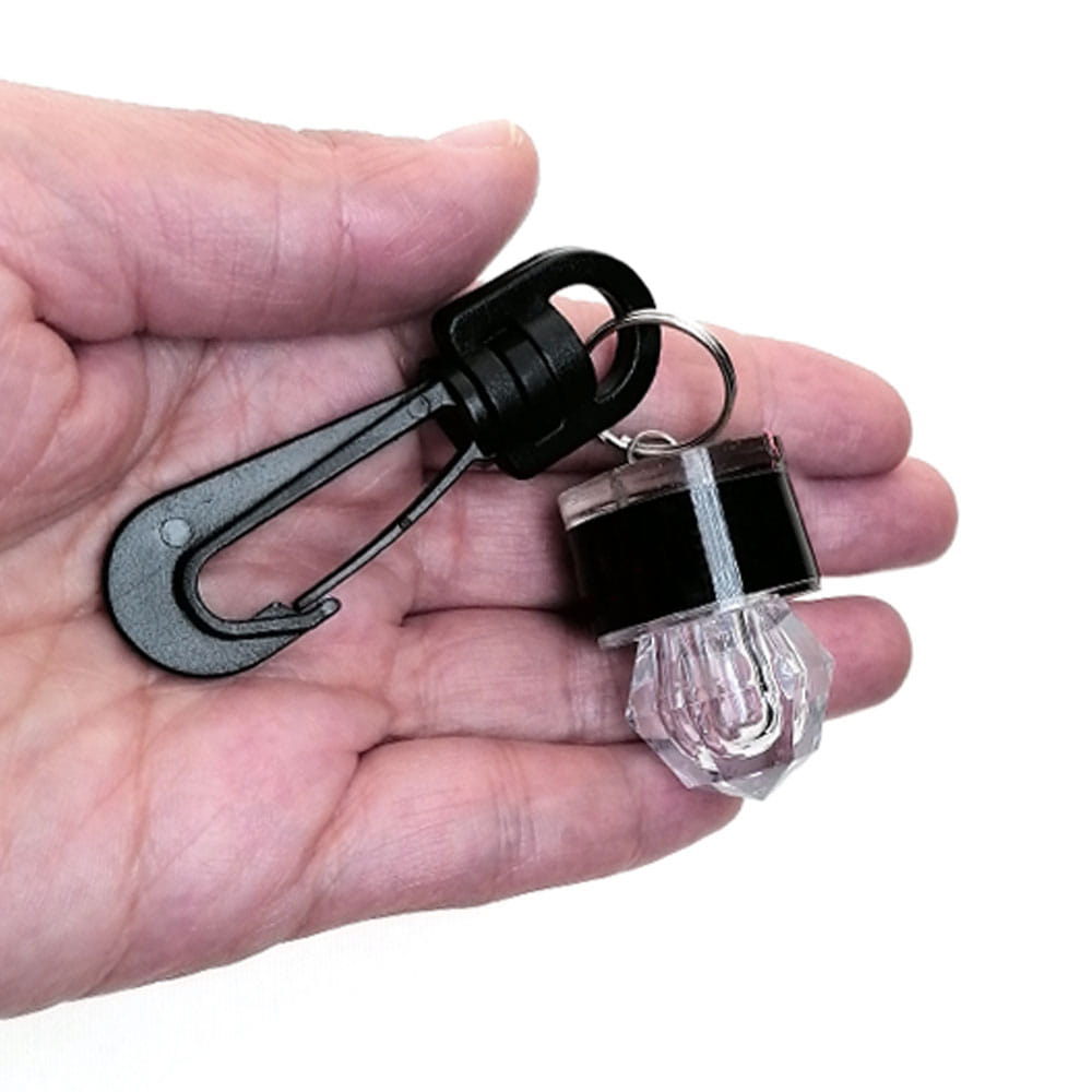 Black and clear scuba diving water activated safety led beacon with a solar-powered keychain light and faceted crystal base.