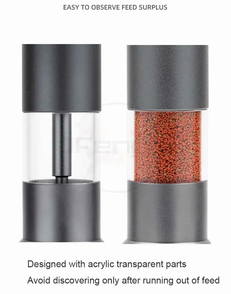Feeder mini aquarium accessories small fish food dispenser with a black and transparent cylindrical body made of clear acrylic showing red-orange pellets inside.