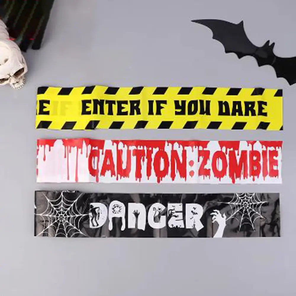 three halloween-themed caution tape strips with bold spooky designs in orange and black for use as halloween caution warning tape barriers.