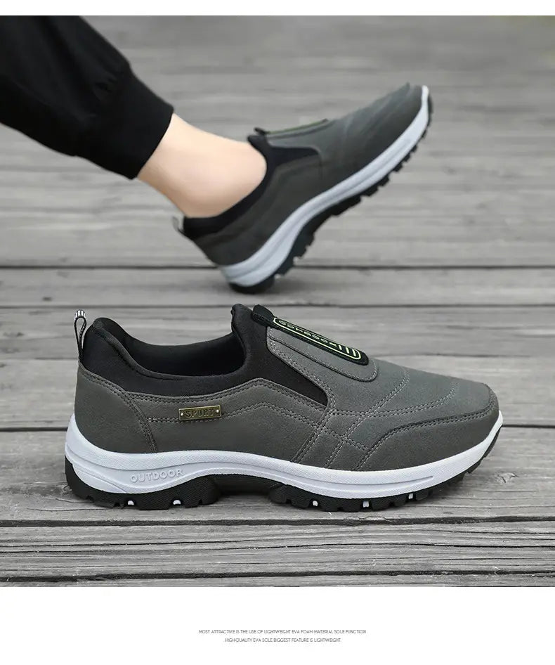 Men orthopedic slip-on walking shoe in gray and black with breathable mesh panels, white midsole, and rubber outsole designed for comfort and support.