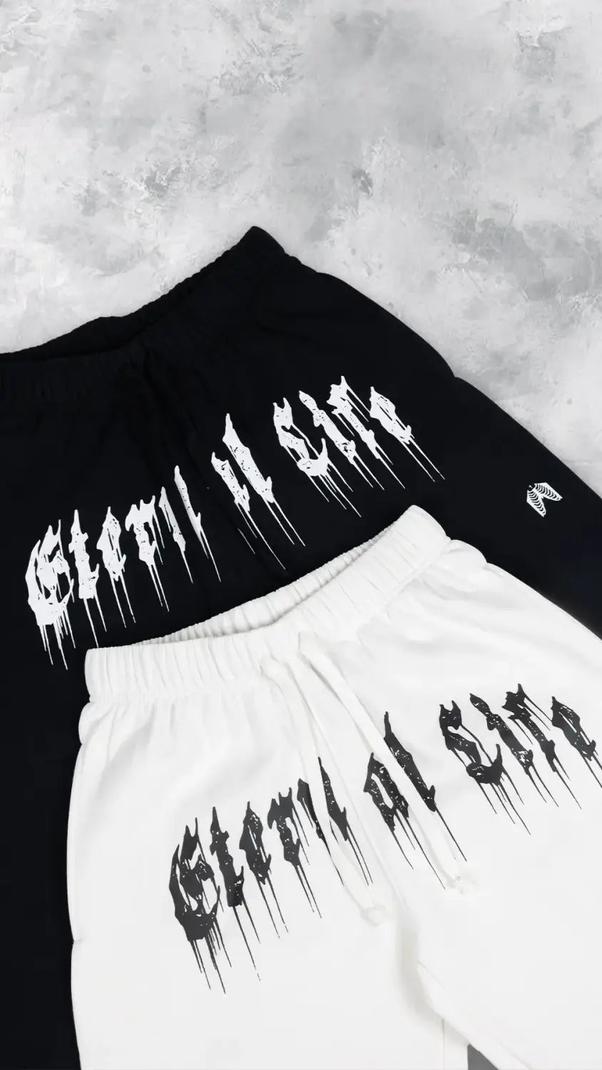 Pantalons d’entraînement graphiques pour hommes, sweatpants noirs et blancs, avec une ambiance gothique de style « gloom al song » qui s’écoule sur l’avant, pour un usage en vêtements d’entraînement.