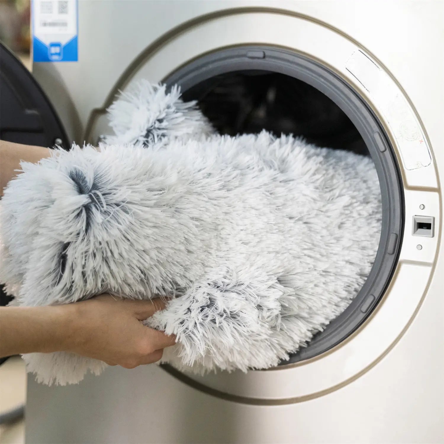 Fluffy white and gray plush faux fur dog bed sofa with long soft fur designed as a washable warm nest.