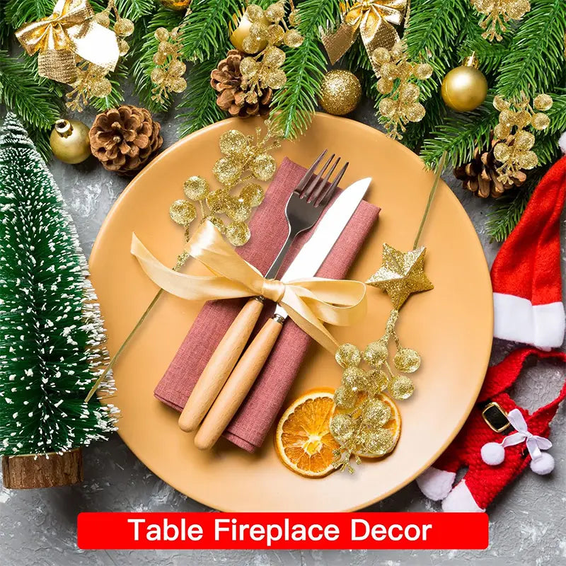 a festive christmas flower bouquet featuring 20pcs christmas decoration glitter berries and golden pine branches arranged around a tan plate with wooden-handled cutlery wrapped in maroon napkins tied with a gold ribbon
