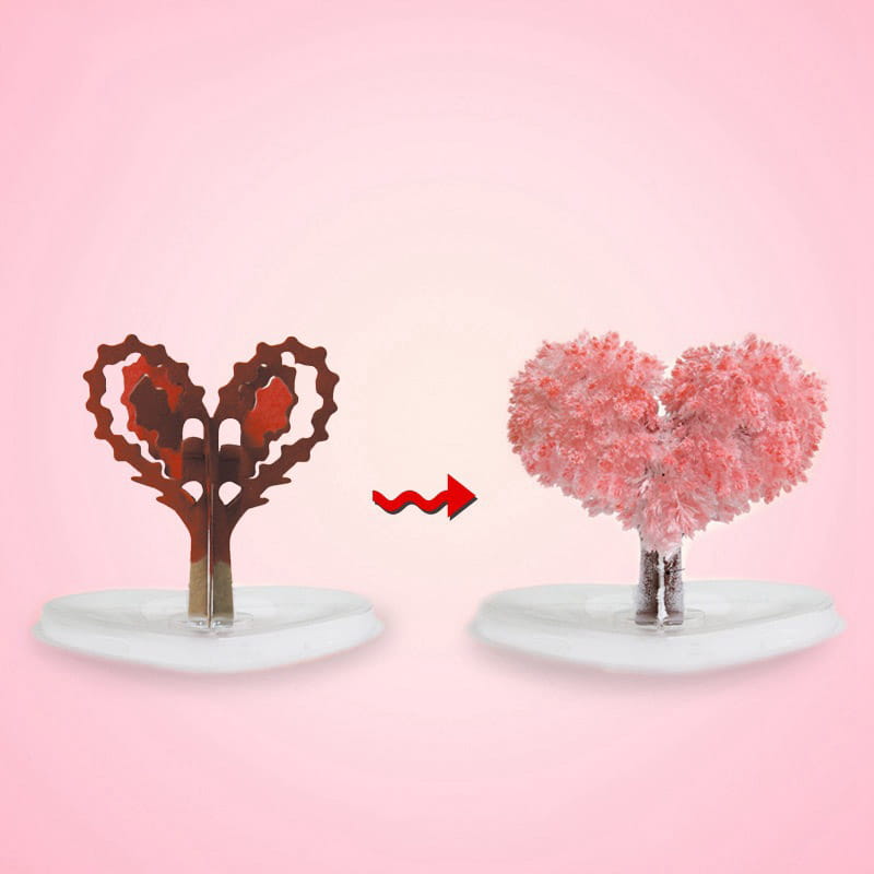 A heart-shaped metallic rust-colored tree ornament with pink floral embellishments featured in the magic growing Christmas tree crystal tabletop toy.