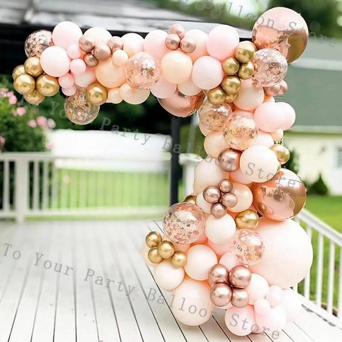 A decorative pink balloon arch kit for wedding and birthday parties featuring pink rose gold and metallic gold balloons with glittery finishes.