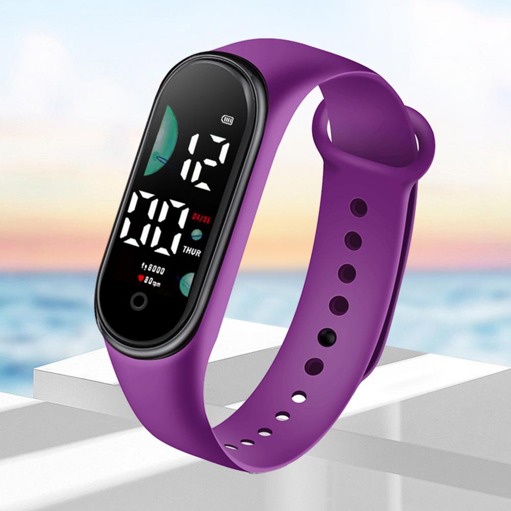 Purple silicone band electronic watch with large font screen black digital display showing time date and heart rate designed for sports use.