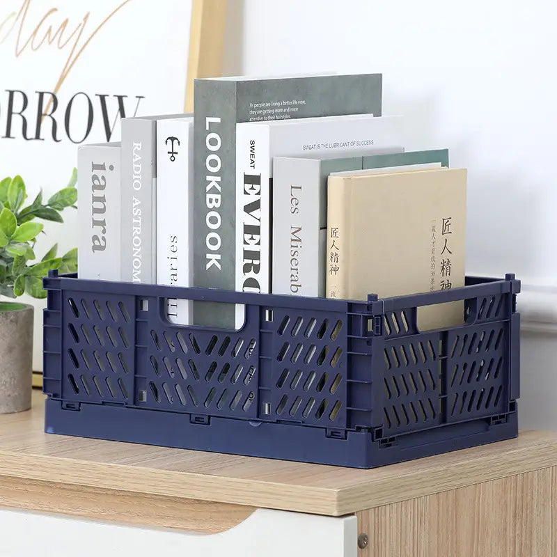 Navy blue plastic foldable storage basket with diamond-shaped perforations designed as a foldable storage crate for versatile storage solutions.