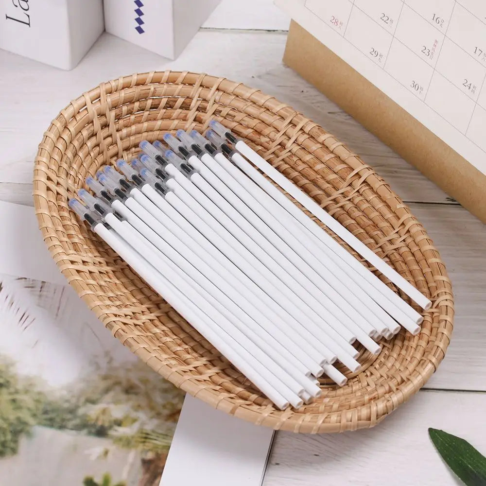 a set of gel pen refills with black ink 10 pack featuring white gel pens with translucent blue and black caps neatly arranged in a woven wicker basket