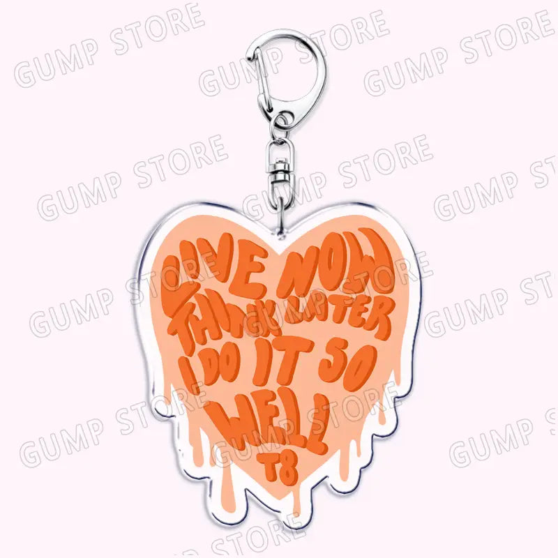 A peach-colored heart-shaped acrylic keychain with a silver metal clasp featuring bold orange lettering live now think later i do it so well from Tate Mcrae acrylic keychain music fan gift.