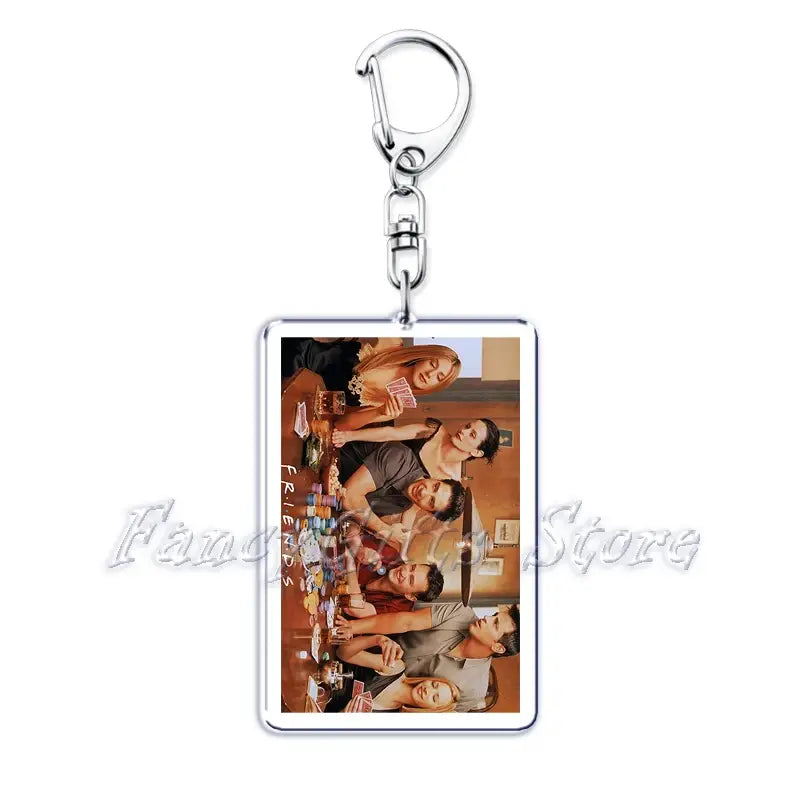 Rectangular acrylic keychain from the movie poster acrylic keychain set featuring vibrant colored print of the Friends TV show cast gathered around a table with a silver metal clasp.