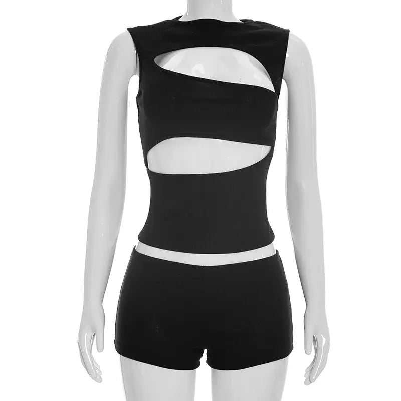 Black ribbed knit sleeveless top and shorts set featuring bold asymmetrical cutouts in a matching black design.