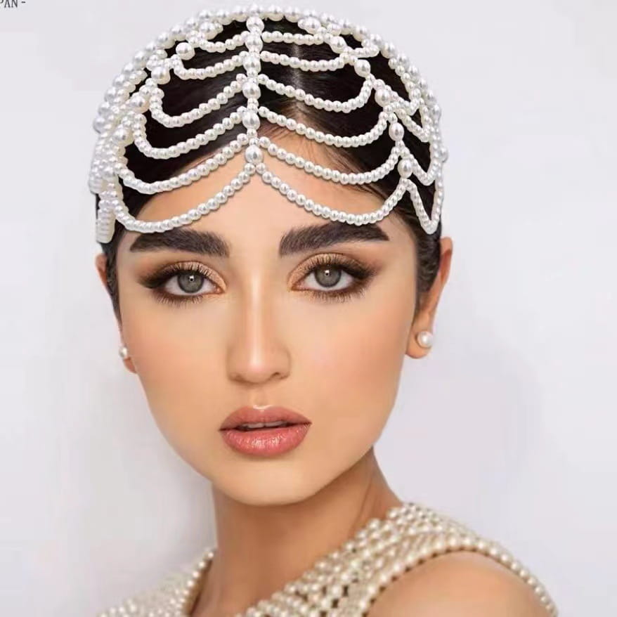 Elegant white pearl bridal crown hair band featuring an intricate cascading beadwork lattice design with tassel accents.