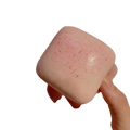 A front view of a soft pink square mini toast slow rising squishy with glittery finish and red speckles