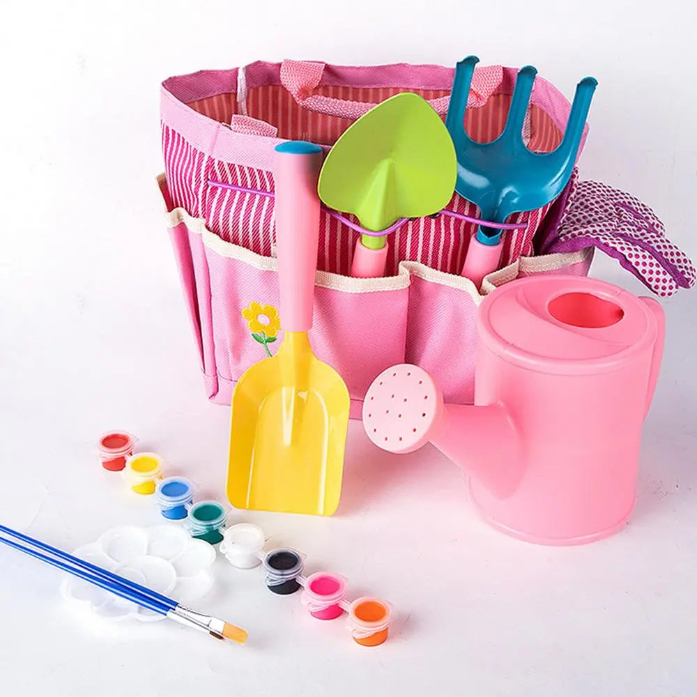 kids gardening set with pink gardening tools including a colorful plastic shovel rake and watering can arranged in a striped fabric tote for easy outdoor use.