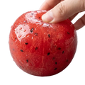 A glossy red handmade watermelon slushy squishy toy with black seeds soft slow rebound stress relief squeeze ball