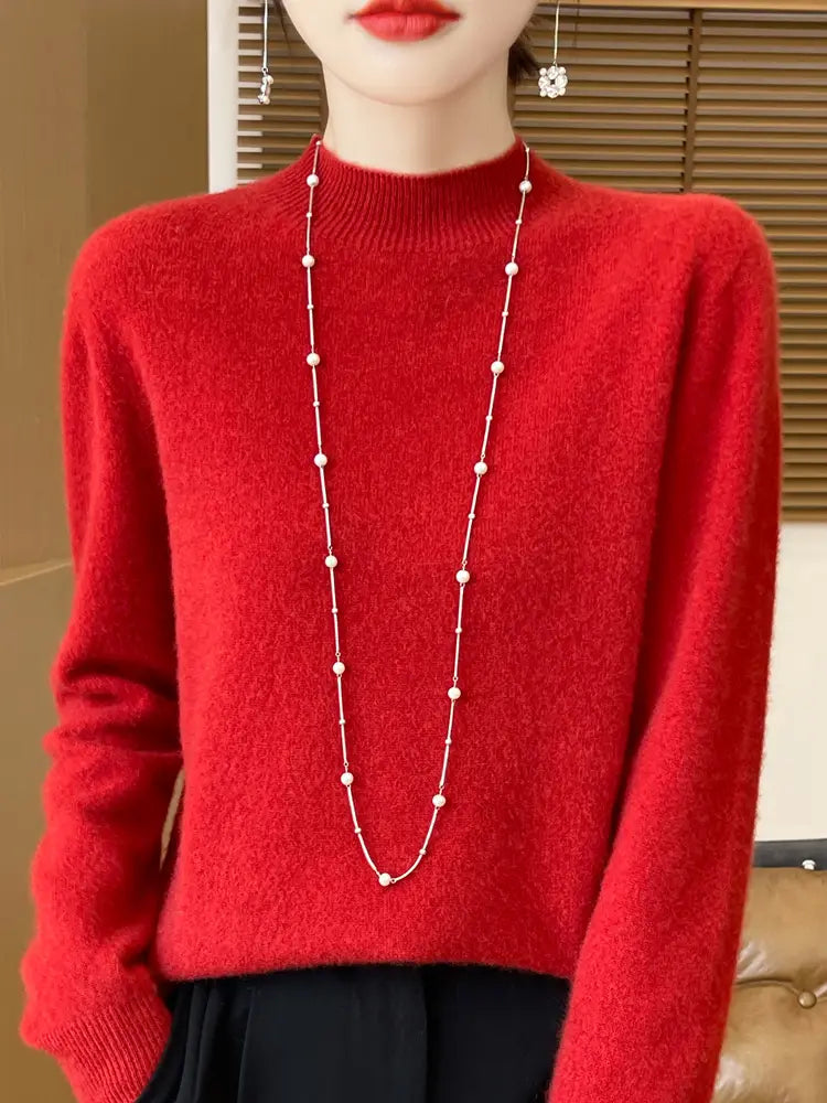 a long elegant necklace with a delicate chain and evenly spaced white pearls paired with a merino wool pullover sweater for women