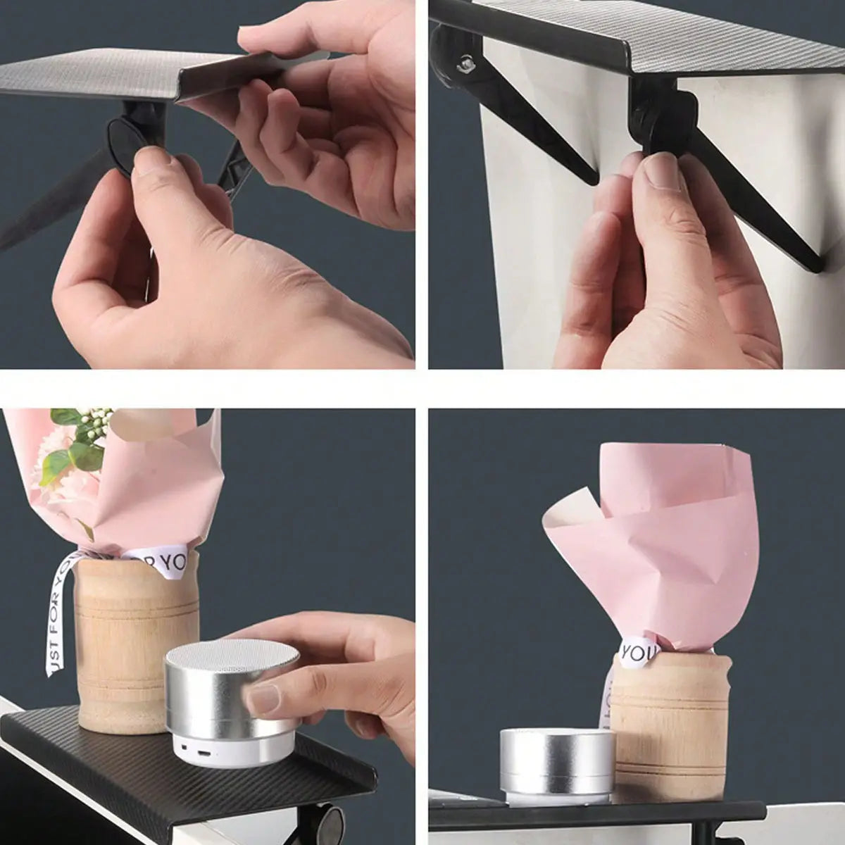 a silver cylindrical portable speaker with a matte finish and white base displayed alongside an adjustable screen top storage shelf monitor stand for organized workspace use