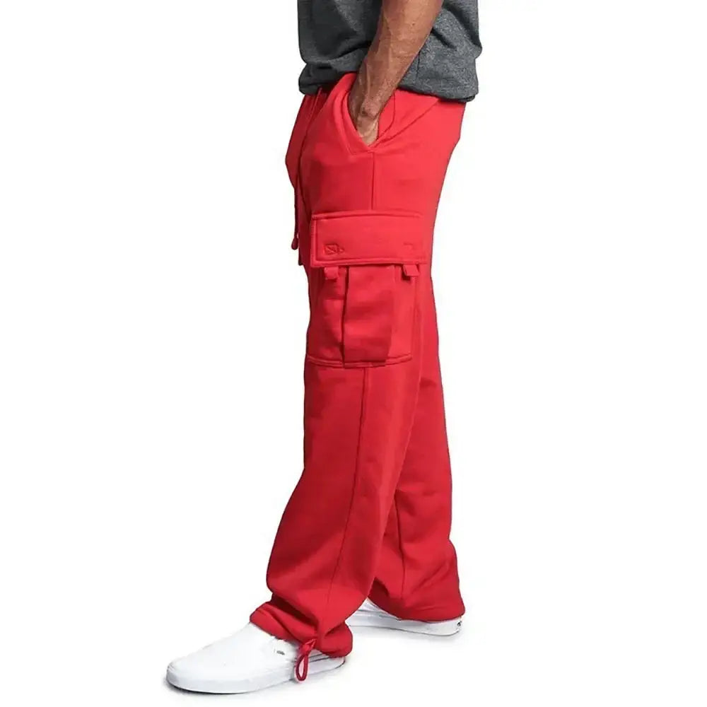 Pantalons cargo rouges pour homme, avec plusieurs poches et des bas de jambe à cordon de serrage, avec une coupe ample, idéals pour une tenue décontractée.