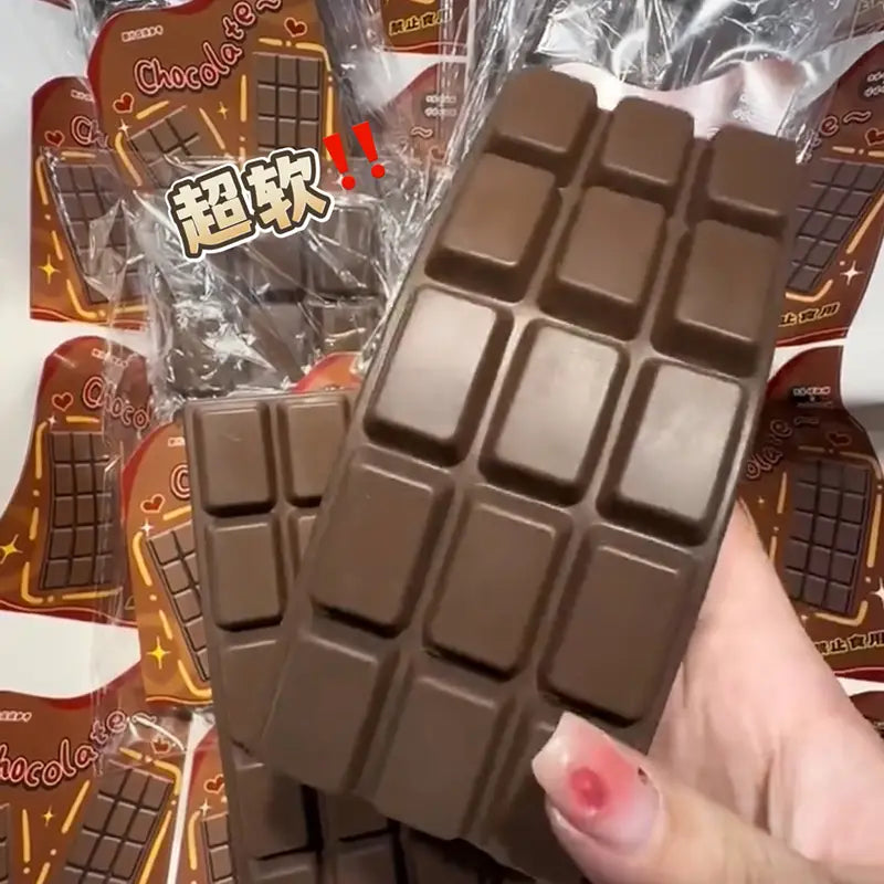 A soft brown chocolate bar squeeze toy slow rising sensory fidget with a grid of square segments designed as a chocolate bar.