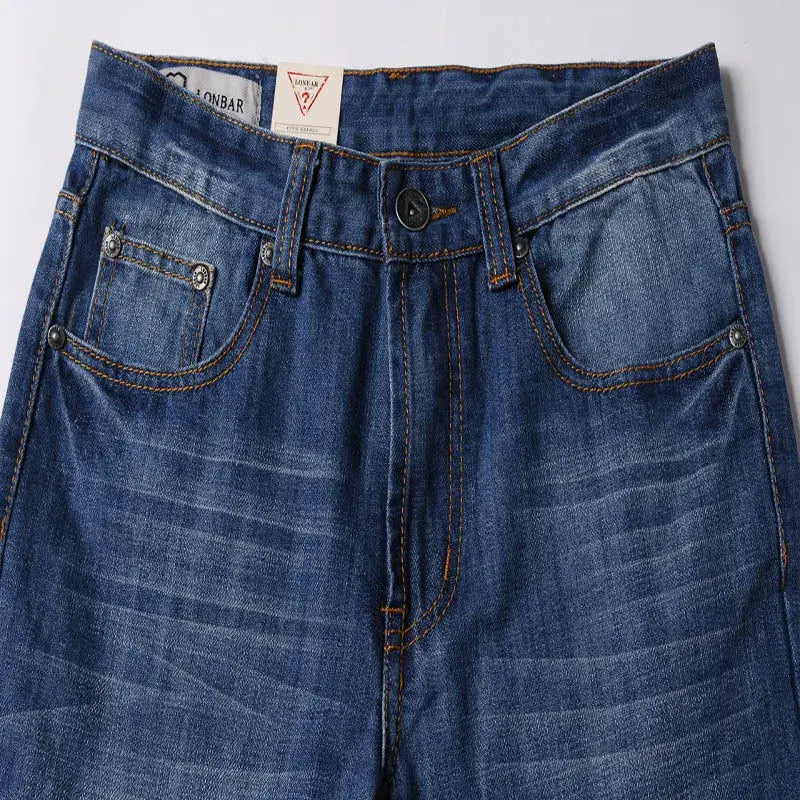Men’s flared denim jeans in dark blue with a classic five-pocket design and contrasting orange stitching ideal for casual wear.